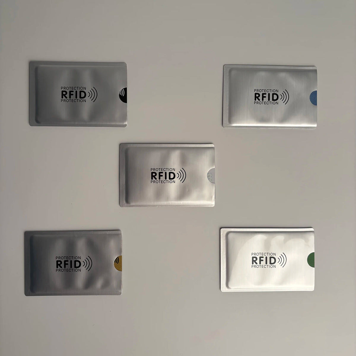 Five rectangular RFID protection card sleeves in various shades of gray and silver.