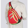 A red medical crossbody bag with yellow accents is worn on a person's back.