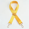 A bright yellow adjustable nylon shoulder strap or sling for bags.