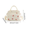 Sac de pique-nique portable en velours côtelé beige avec un motif clair et des détails en tissu.
