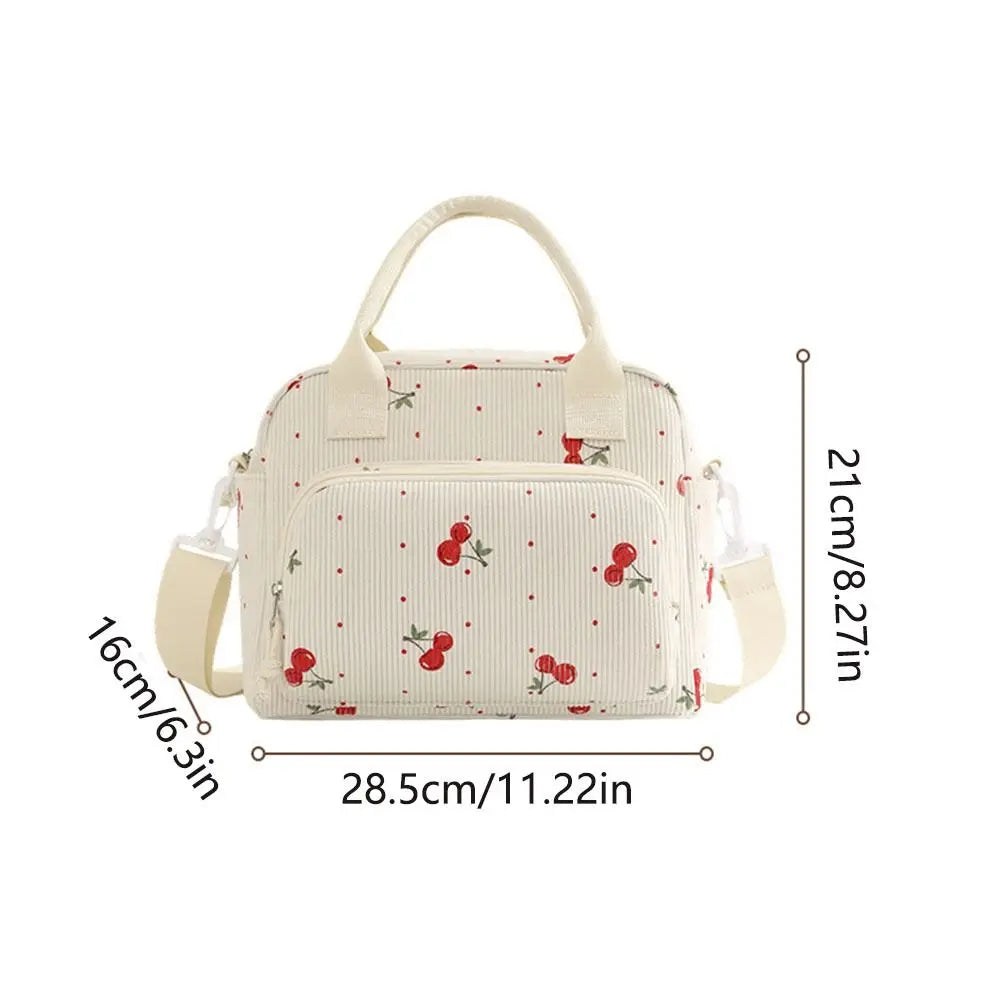 Sac de pique-nique portable en velours côtelé beige avec un motif clair et des détails en tissu.