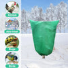 A green plant protection cover with a zipper and drawstring is shown against a snowy winter background.