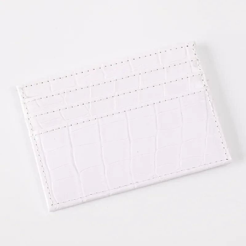 A white slim PU leather card holder wallet with a textured crocodile pattern.