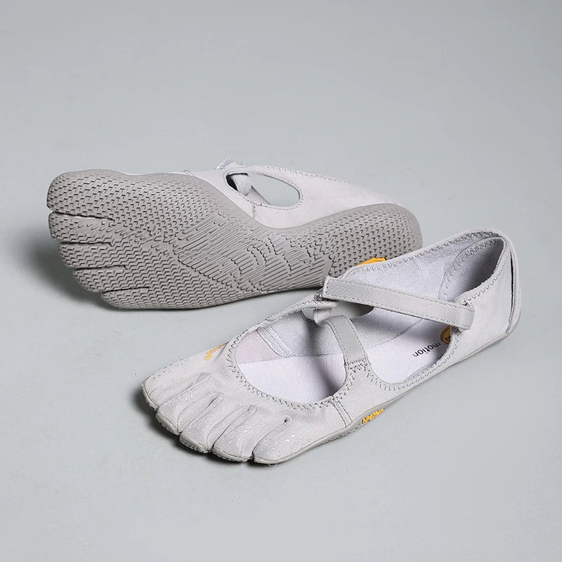 A pair of light gray women's barefoot five-toe shoes with an adjustable strap shown from the top and side.