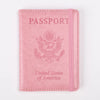 A pink leather passport holder with embossed text and an eagle emblem.