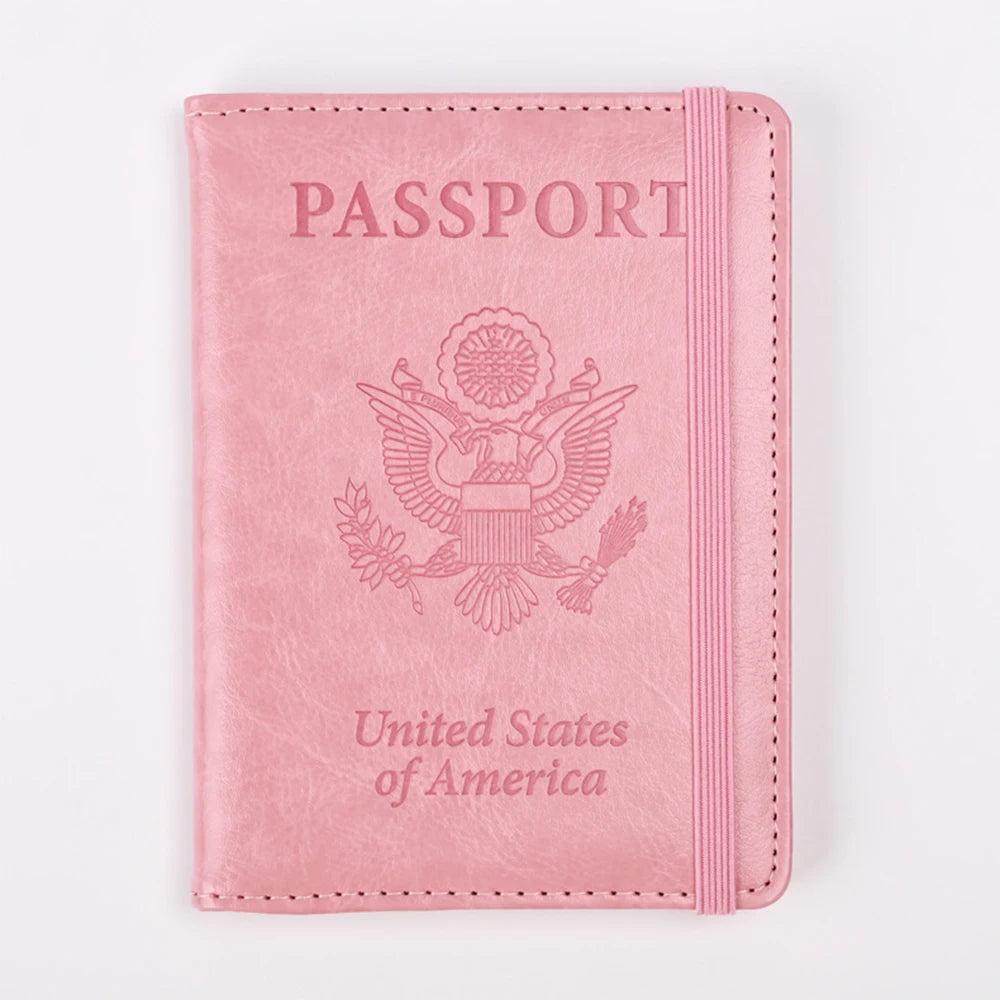 A pink leather passport holder with embossed text and an eagle emblem.