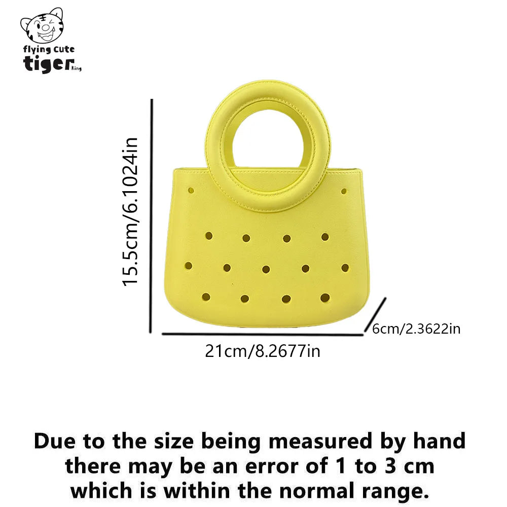 Yellow round PVC handbag with a perforated design and a loop handle