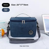 Navy blue insulated portable lunch bag with a shoulder strap shown on a white surface.