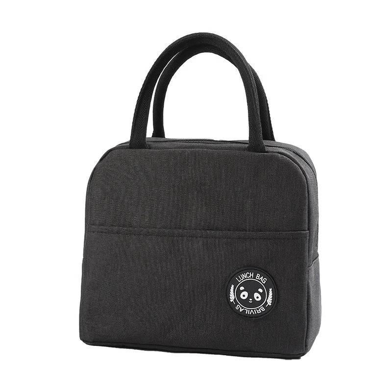 Black insulated lunch bag with a handle featuring a smiling bear design.