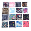 A collection of colorful fabric squares featuring various floral, animal, and geometric prints for storage or grocery use.