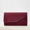 A deep burgundy velvet evening clutch with a smooth finish and a visible gold-colored edge.