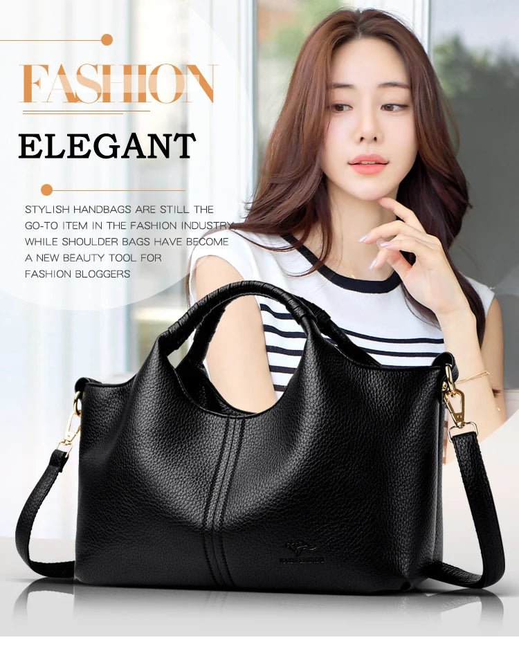 A woman models a black luxury soft leather tote bag in a studio setting.