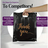 A black plastic gift bag with gold lettering that says Thank you is being held by a hand.
