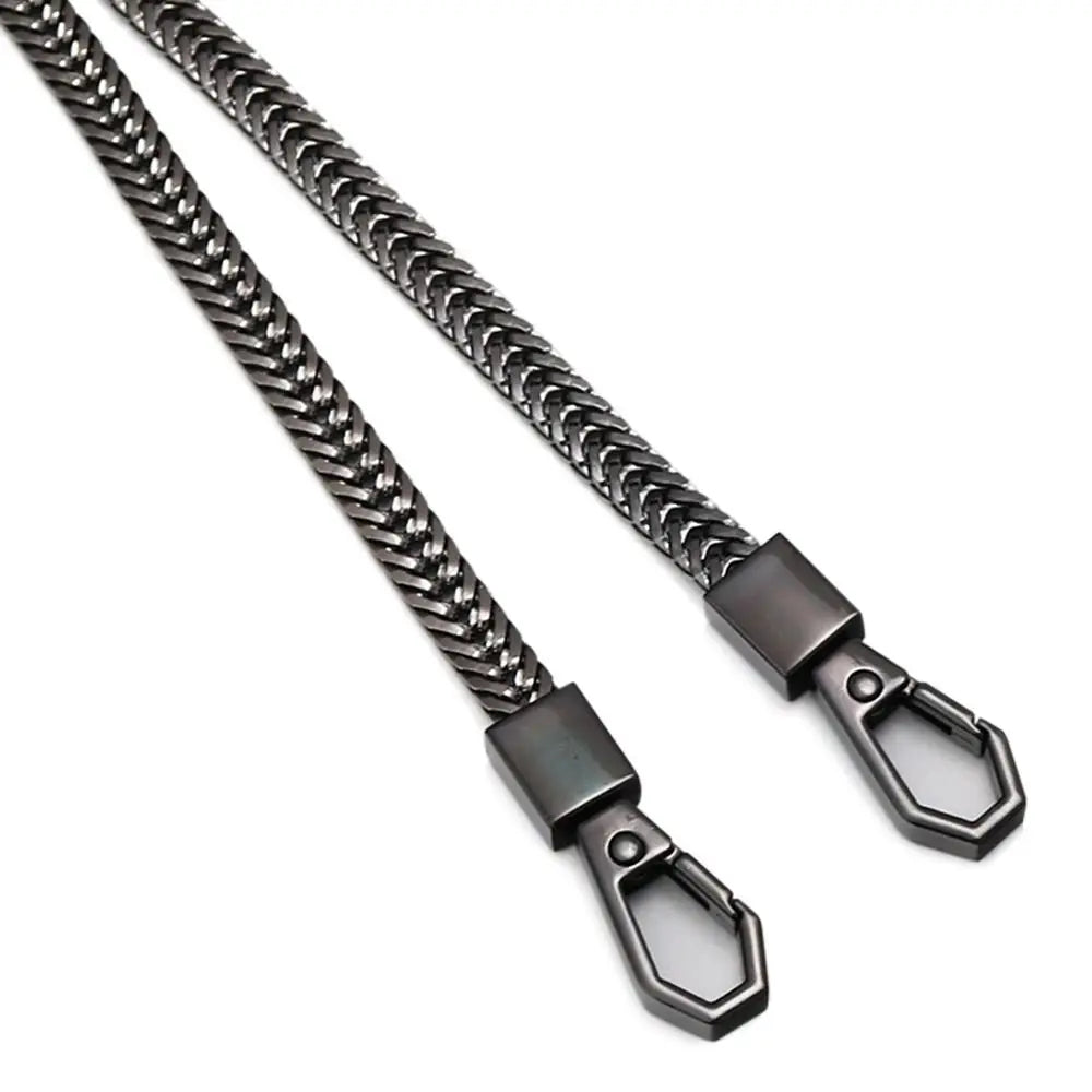 A close-up view of a dark metal bag chain strap with a lobster clasp, used as a replacement purse chain.
