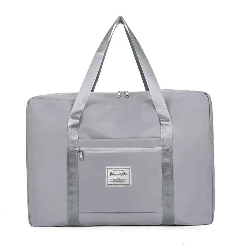 A light gray canvas travel storage bag with a handle and zipper pocket.