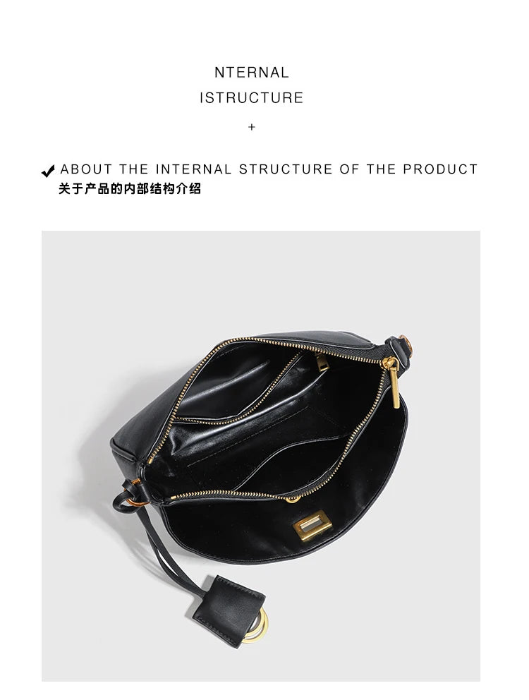 A black split leather shoulder tote bag with gold hardware shown against a light gray background.