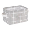 A gray and white checkered storage basket made of waterproof cotton linen for desk organization.