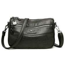 A black leather trendy women's crossbody bag with silver hardware and a flap closure.