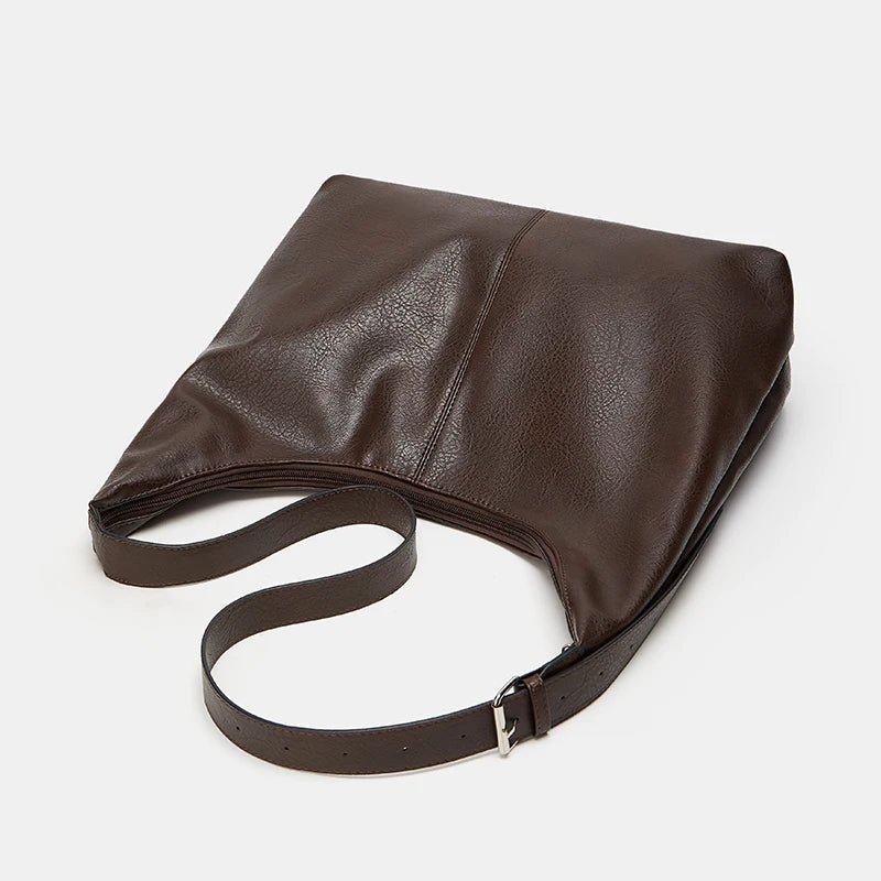 A brown soft PU leather retro tote bag with a zipper closure shown from the side.