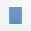 A light blue customizable PU leather passport holder with stitched edges.