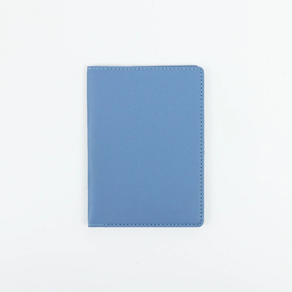 A light blue customizable PU leather passport holder with stitched edges.