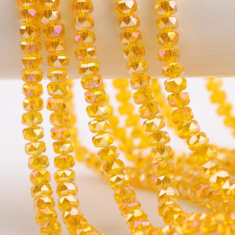 Yellow faceted crystal glass beads in a wheel shape strung on a string