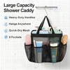 Black portable mesh shower caddy with handles and 8 pockets hanging on a tiled wall.