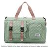 A light green nylon travel duffle bag with pink straps and a quilted pattern.