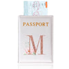 A pink leather passport holder with a gold embossed letter M and a floral design.