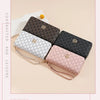A collection of four patterned wallets in brown, gray, black, and pink leather with gold accents.