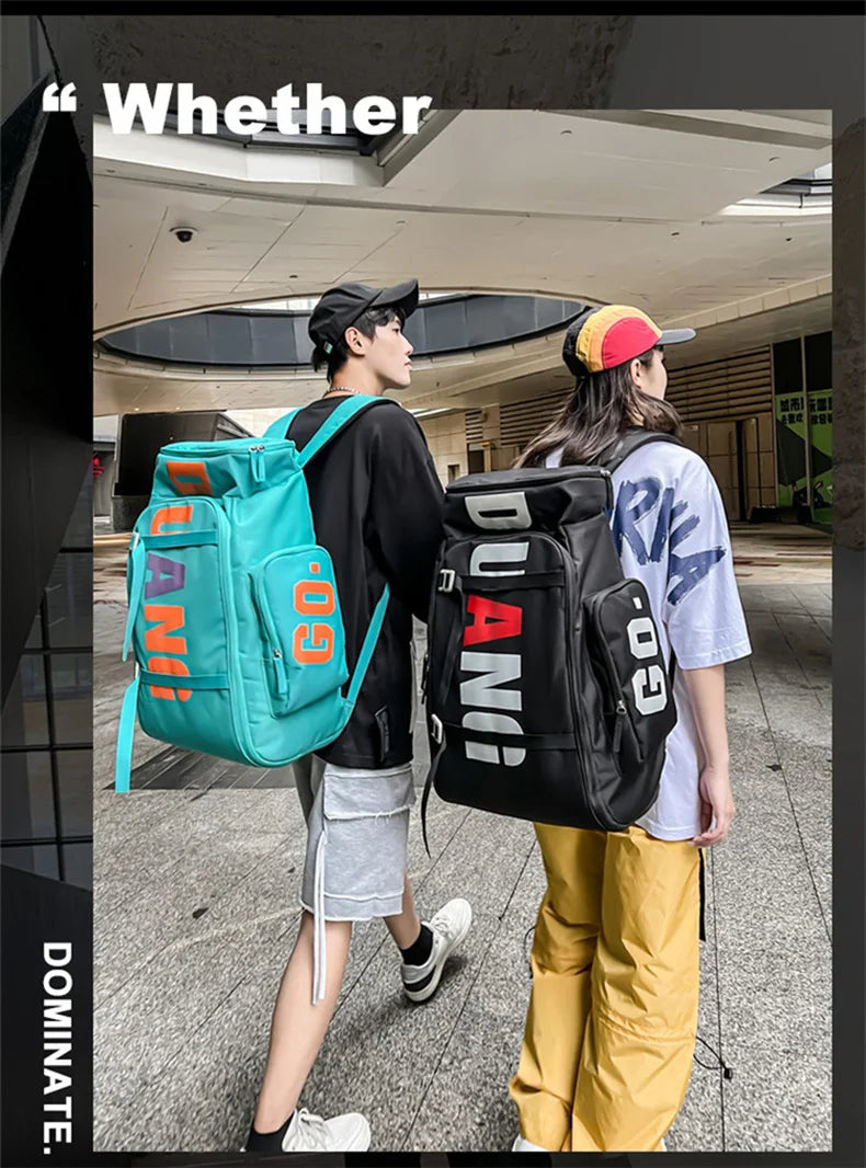 A person wearing a black shirt and gray shorts is carrying an orange backpack while standing in a modern indoor space.