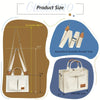A beige canvas tote handbag with white interior and brown leather accents, shown with adjustable shoulder straps.