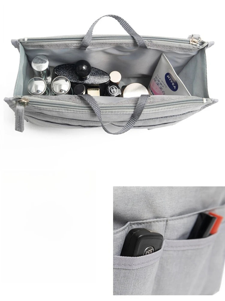 A gray fabric handbag with an interior organizer insert showing various small cosmetic and accessory items.