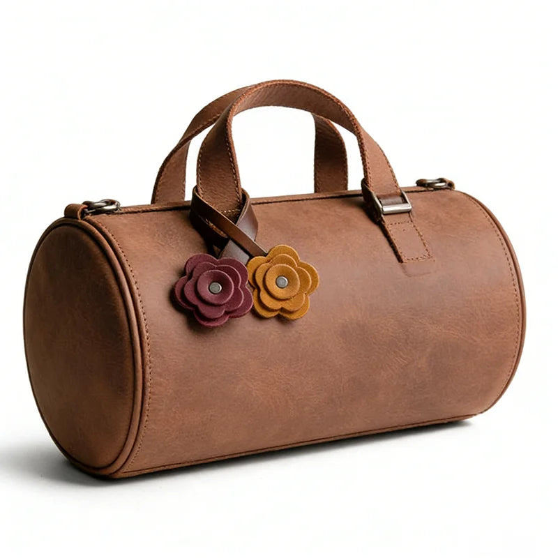 A brown handmade PU leather bag with rose-shaped charms attached to the strap.