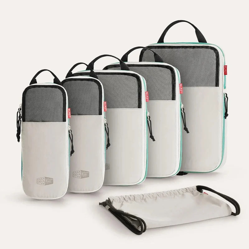 A set of six gray and white expandable compression packing cubes shown in various orientations.