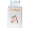 A pink leather passport holder with a gold embossed letter A design and an attached passport.