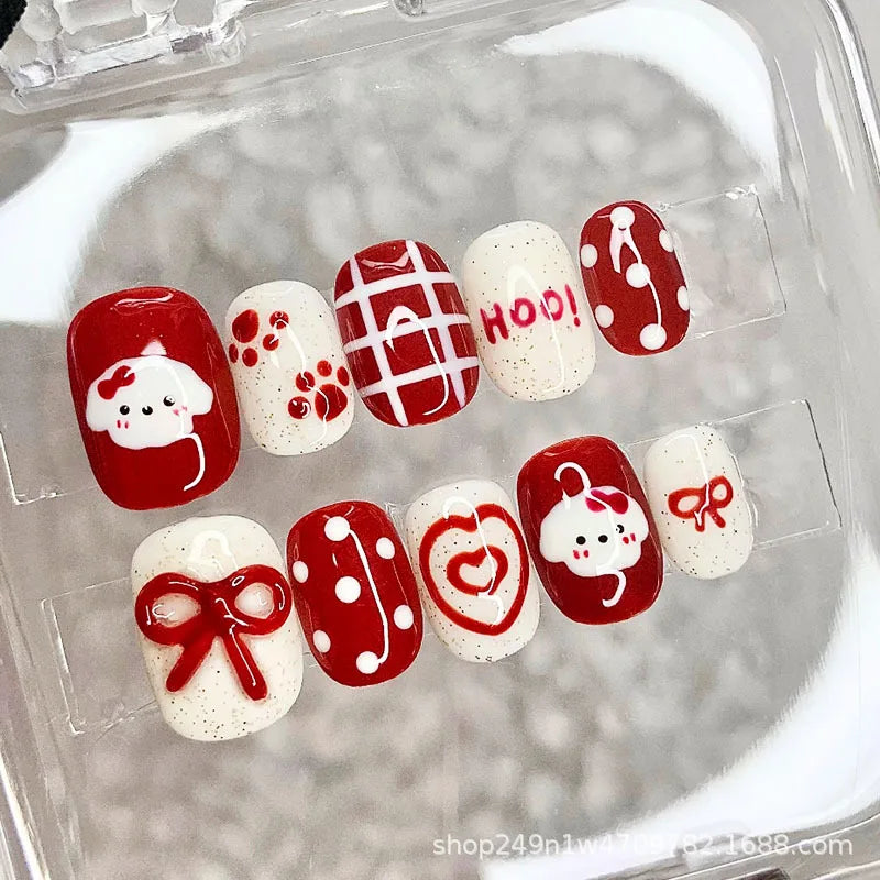 A set of 30 cute cartoon press-on nails in red and white designs are displayed in a clear container.