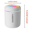 A white mini USB electric aroma diffuser with a multicolored light, shown from the side.