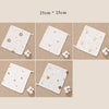 A set of white muslin baby burp cloth towels featuring various cute animal and floral patterns.