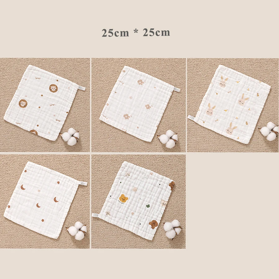 A set of white muslin baby burp cloth towels featuring various cute animal and floral patterns.
