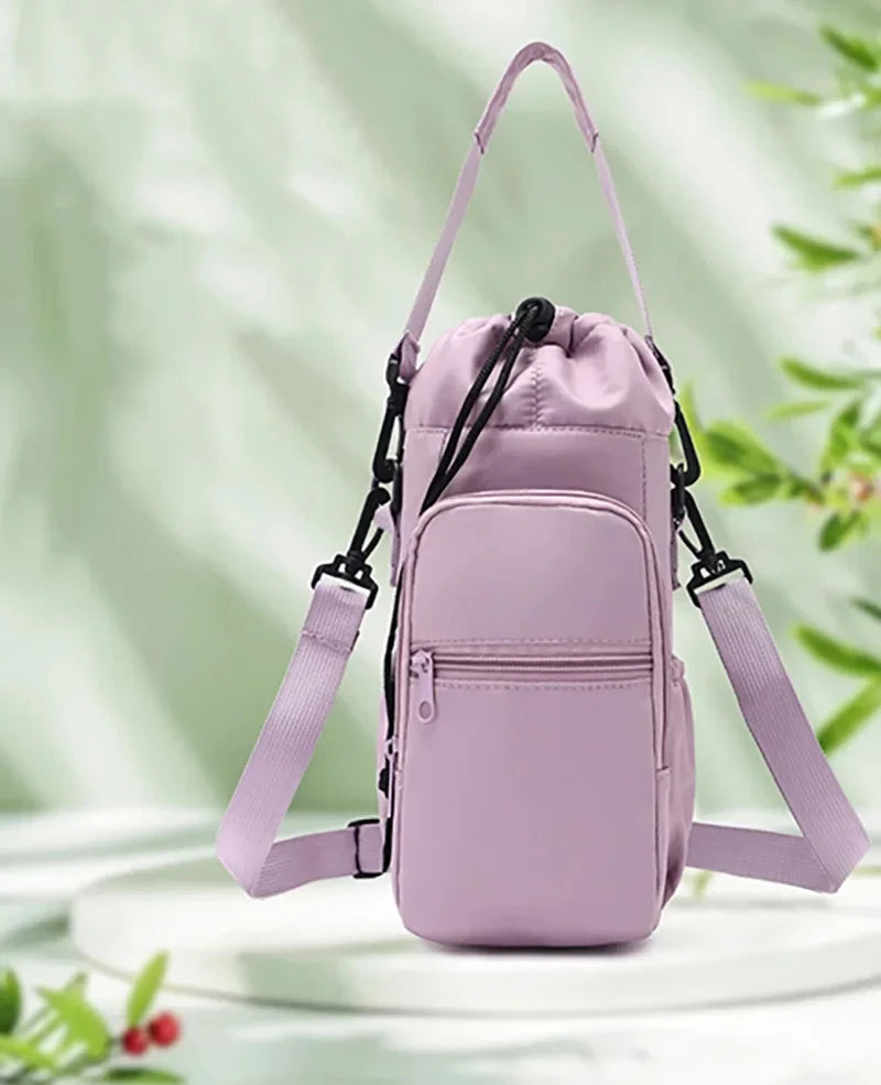 A light purple thermal water bottle bag with adjustable straps is shown against a bright green, leafy background.