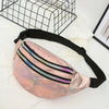 A pink holographic sequin waist bag with a black adjustable strap is displayed on a white surface.