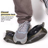 A close-up of a reusable insulated water bladder hydration bottle placed on a person's foot.