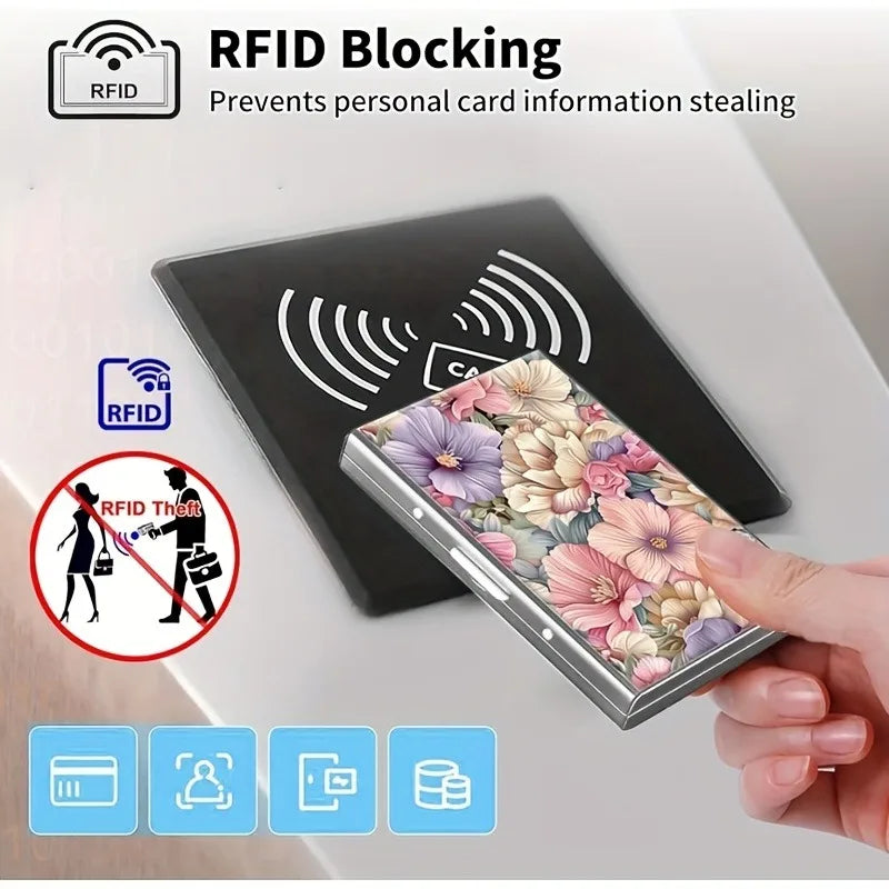 A hand holds a metal card holder with a floral design, demonstrating RFID blocking technology.