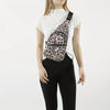 A woman wearing a white top and black pants carrying a patterned quilted crossbody sling bag.