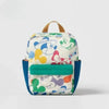 A light-colored fashion backpack featuring a cow print pattern and a green accent panel.