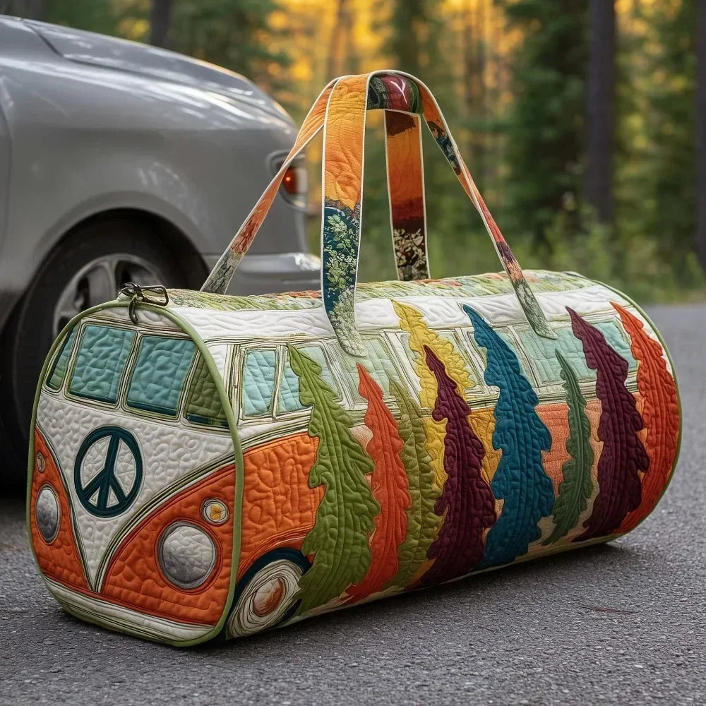 A quilted travel duffle bag featuring a colorful, nature-inspired floral pattern resting on asphalt.
