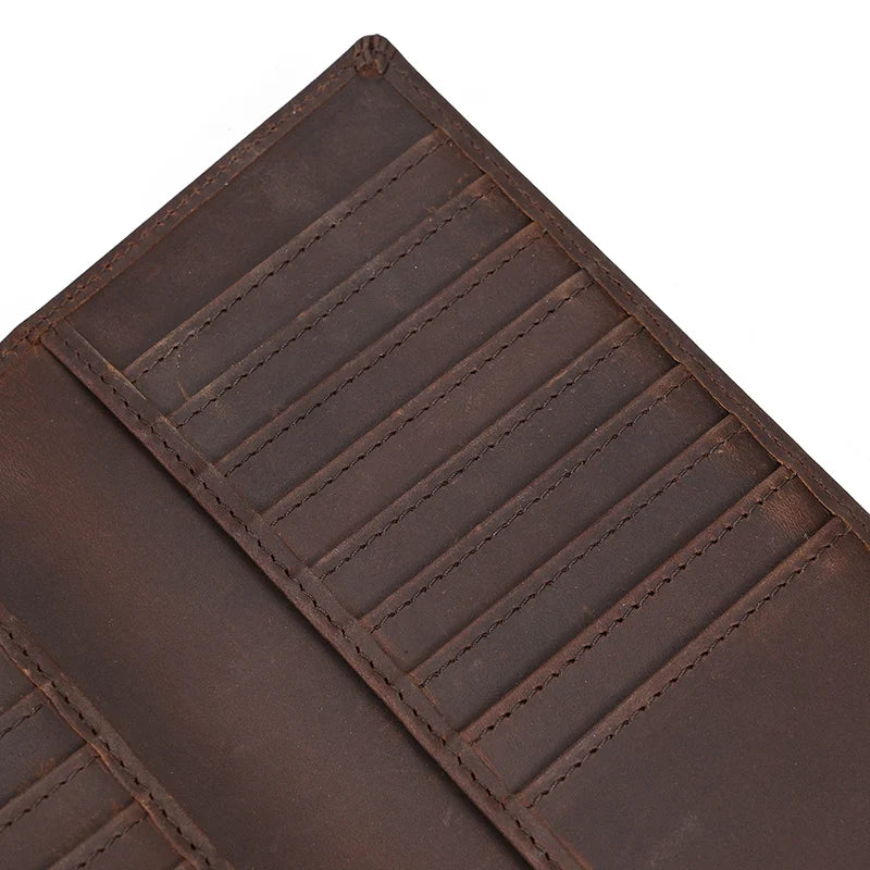 A close-up view of a brown genuine leather bi-fold wallet with stitched lines.