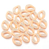 A collection of light peach colored acrylic link chain connectors for DIY jewelry and bag making