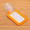 An orange plastic luggage tag with blank lines for name, address, and state, attached to a clear plastic loop.